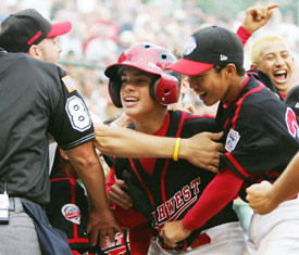 Michael Memea is swarmed by teammates after his walk-off homer